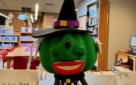 Pumpkin decorated like a witch.