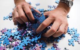 Hands holding puzzle pieces.