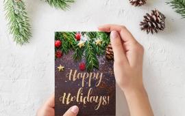 Hands holding a holiday card.