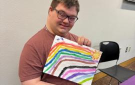 Person holding artwork.