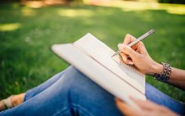 Person writing in a notebook.