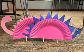 Dinosaur made from a paper plate and other supplies.