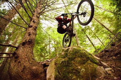 Cyclist riding over rock