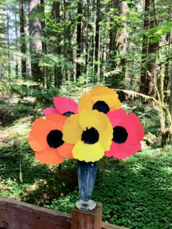 Paper poppies made using fall colors of orange, red, and yellow.