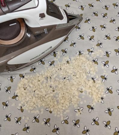 An iron with parchment paper and wax.