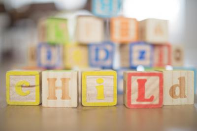 Colorful building blocks spelling out the word "child".