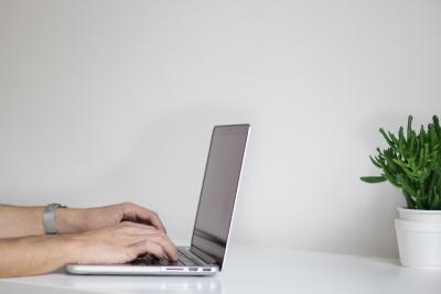 Person typing on a laptop.