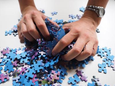 Hands holding puzzle pieces.