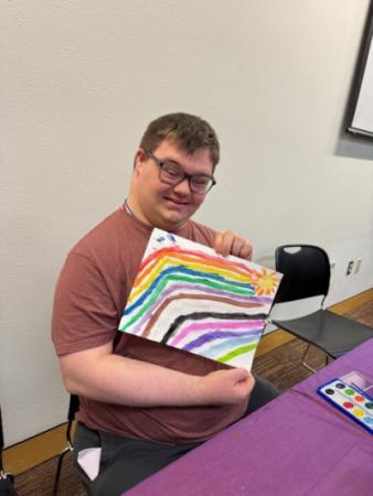 Person holding artwork.