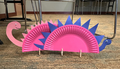 Dinosaur made from a paper plate and other supplies.